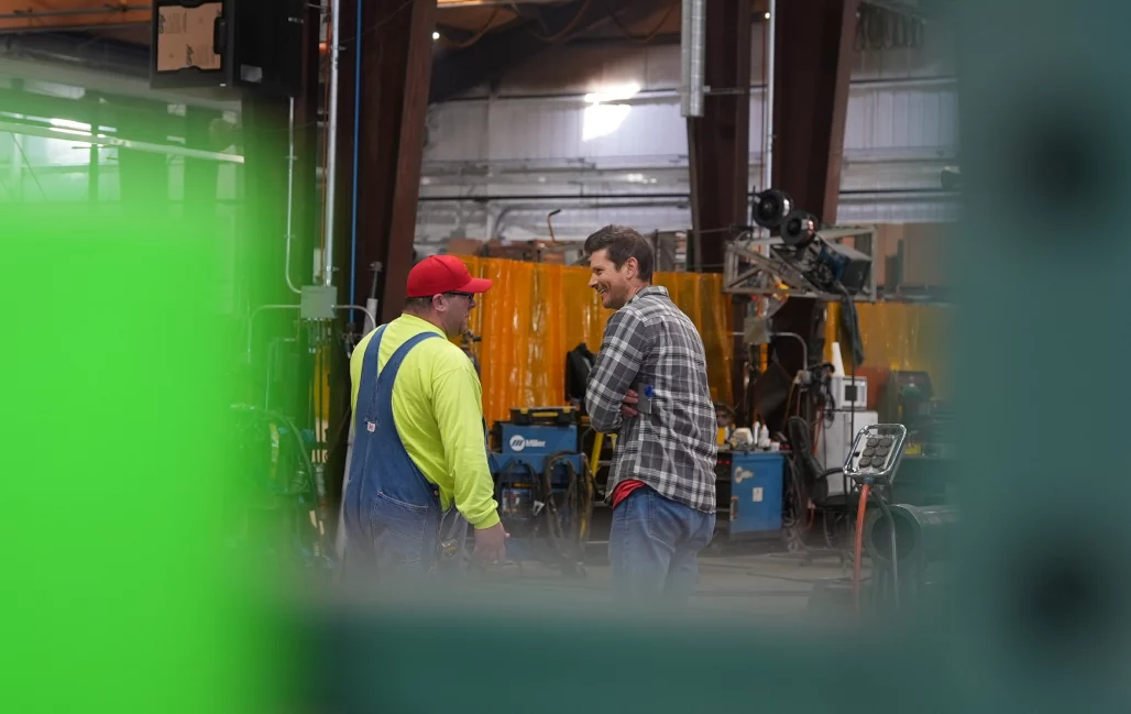 Paul Skelton, our director of product design and development, chats with an AT Industries employee.